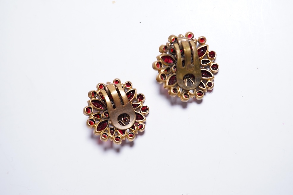 A suite of garnet and paste jewellery, comprising: a brooch, 5cm diameter; a bangle, inner circumference 16cm; two rings, sizes I and M; a pair of earrings, and a single earring, each set with rose-cut garnets; and a pai